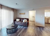 Thumbnail 1 of 29 - A living room with a brown couch and a coffee table.