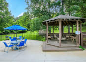 Thumbnail 10 of 13 - a patio with a gazebo and tables and chairs