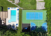 Thumbnail 34 of 36 - An aerial view of a tennis court and a swimming pool.