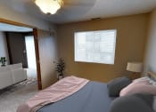 Thumbnail 4 of 10 - a bedroom with a bed and a window