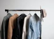 Thumbnail 8 of 10 - a rack of clothes with a hat on top of it