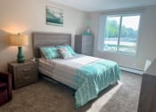 Thumbnail 6 of 20 - a bedroom with a bed and a large window