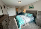 Thumbnail 5 of 20 - a bedroom with a bed and a dresser