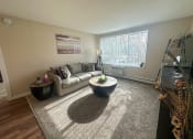 Thumbnail 4 of 20 - a living room with a couch and a table