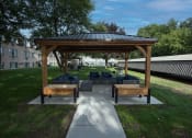 Thumbnail 16 of 20 - a pavilion with a couch and tables on a patio