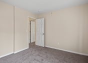 Thumbnail 9 of 20 - a bedroom with beige walls and carpet