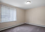 Thumbnail 8 of 20 - an empty bedroom with a large window