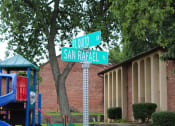 Thumbnail 30 of 31 - a street sign in front of a playground