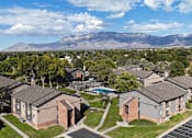 Thumbnail 33 of 35 - A view of apartment buildings with a mountain range in the background.
