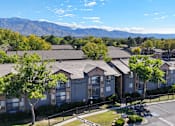 Thumbnail 28 of 35 - Apartment complex with a mountain range in the background.