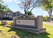 Thumbnail 32 of 35 - A sign for Sedona Ridge Apartments is in front of a tree and a building.