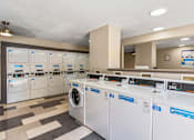 Thumbnail 14 of 35 - A row of washing machines in a laundromat.
