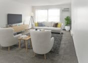 Thumbnail 2 of 8 - a living room with two chairs and a couch
