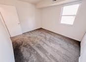 Thumbnail 11 of 13 - an empty room with carpet and a window