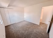 Thumbnail 8 of 13 - an empty bedroom with white walls and a closet