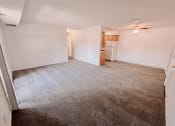Thumbnail 2 of 13 - apartment living room with a kitchen and dining area in the background