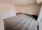 Thumbnail 5 of 13 - an empty living room with carpeting and white walls