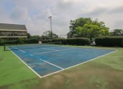 Thumbnail 10 of 17 - a blue tennis court at apartment community