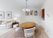 Thumbnail 3 of 33 - A modern dining room with a wooden table and chairs.