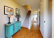 Thumbnail 5 of 17 - a living room with stairs and a blue dresser