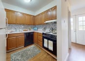 Thumbnail 1 of 17 - a kitchen with black appliances and wooden cabinets