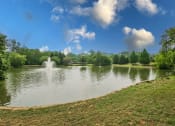 Thumbnail 14 of 17 - a fountain in the middle of a lake at apartment community