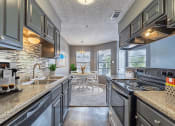 Thumbnail 9 of 26 - kitchen with updated appliances at summit on the lake apartments