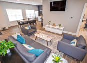 Thumbnail 20 of 33 - a living room with couches and a tv