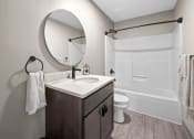 Thumbnail 6 of 33 - a bathroom with a sink and a shower and a mirror