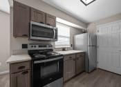 Thumbnail 3 of 33 - a kitchen with stainless steel appliances and a window