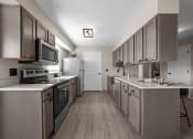 Thumbnail 4 of 33 - a kitchen with stainless steel appliances and white counter tops