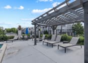 Thumbnail 25 of 33 - an outdoor patio with lounge chairs and a pergola