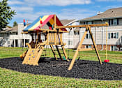 Thumbnail 20 of 28 - A wooden swing set with a red ball on the ground.