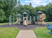 Thumbnail 21 of 33 - a playground with a swing set and slides in a park