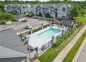 Thumbnail 23 of 33 - an aerial view of a swimming pool in front of an apartment building