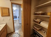 Thumbnail 15 of 28 - A kitchen with a pantry door open to a living room.