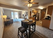 Thumbnail 1 of 28 - A living room with a dining table and chairs.