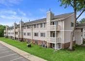 Thumbnail 24 of 28 - an image of an apartment building with green grass and trees at sun valley apartments