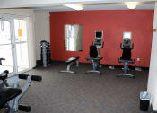 Thumbnail 21 of 28 - private fitness center at Sun Valley apartments with gym equipment.