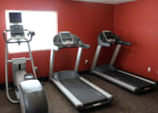 Thumbnail 22 of 28 - a gym with two treadmills and other exercise equipment at sun valley apartments