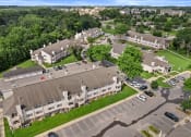 Thumbnail 28 of 28 - an aerial view of an apartment complex with cars parked in a parking lot