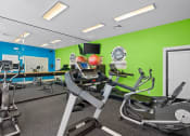 Thumbnail 21 of 29 - a gym with various exercise equipment and mirrors