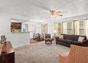 Thumbnail 8 of 29 - a living room with a couch and a ceiling fan