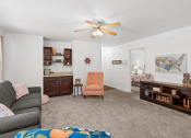 Thumbnail 7 of 29 - a living room with a couch and a ceiling fan