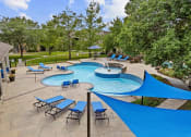 Thumbnail 24 of 29 - a resort style pool with blue umbrellas and chairs