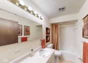 Thumbnail 9 of 10 - bathroom with a sink, toilet, and a tub