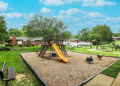Thumbnail 2 of 10 - playground with a swing set at apartment