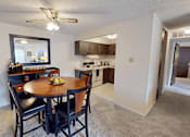 Thumbnail 4 of 33 - A kitchen with a dining table and chairs.