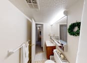 Thumbnail 8 of 15 - A bathroom with a white towel hanging on the towel rack.