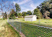 Thumbnail 12 of 15 - A chain link fence runs along a grassy area.
